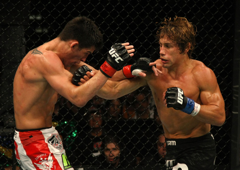 Urijah Faber punches Dominick Cruz during their bout at UFC 132 on 7/2/11 in Las Vegas, NV (Photo by Donald Miralle/Zuffa LLC)