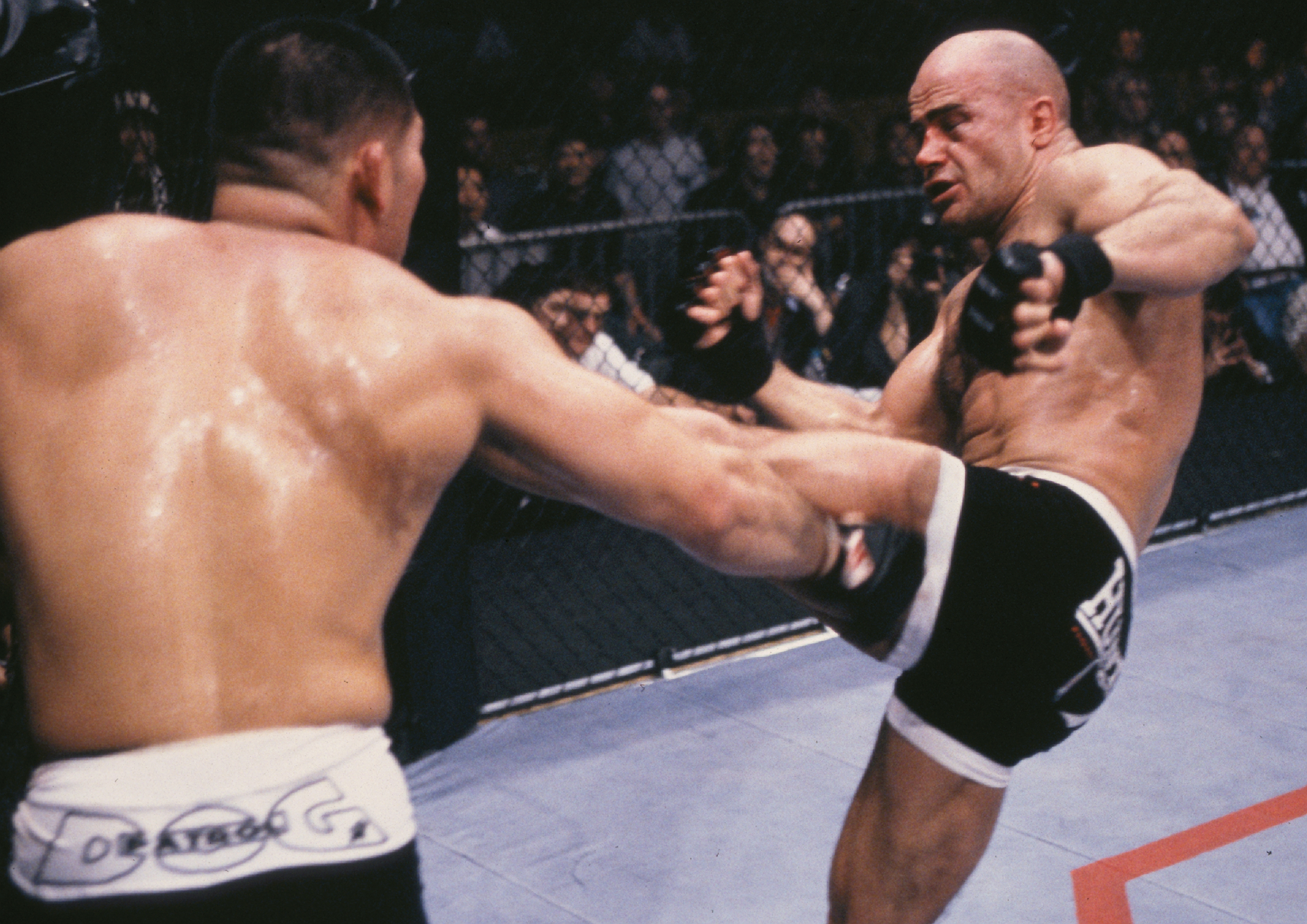 Bas Rutten (R) kicks Tsuyoshi Kosaka during their bout at UFC 18 on January 8, 1999 in Kenner, Louisiana. (Photo by Josh Hedges/Zuffa LLC)