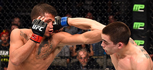 (R-L) Ryan Benoit lands a punch on Sergio Pettis in their flyweight bout during the UFC 185 event on March 14, 2015 in Dallas, Texas. (Photo by Josh Hedges/Zuffa LLC)