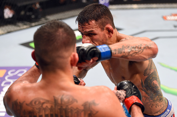 (R-L) Rafael dos Anjos of Brazil punches Anthony Pettis in their championship bout during the UFC 185 event on March 14, 2015 in Dallas. (Photo by Josh Hedges/Zuffa LLC)