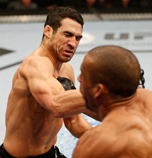 (L-R) Danny Castillo punches Edson Barboza in their lightweight bout during the UFC on FOX event at Sleep Train Arena on December 14, 2013 in Sacramento, CA. (Photo by Josh Hedges/Zuffa LLC)