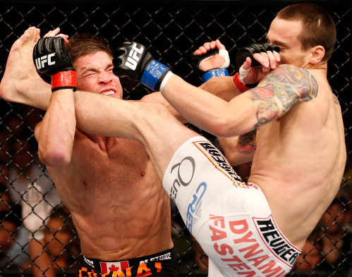 (R-L) James Krause kicks <a href='../fighter/Sam-Stout'>Sam Stout</a> in their lightweight fight during the UFC 161 event at the MTS Centre on June 15, 2013 in Winnipeg, Manitoba, Canada. (Photo by Josh Hedges/Zuffa LLC)