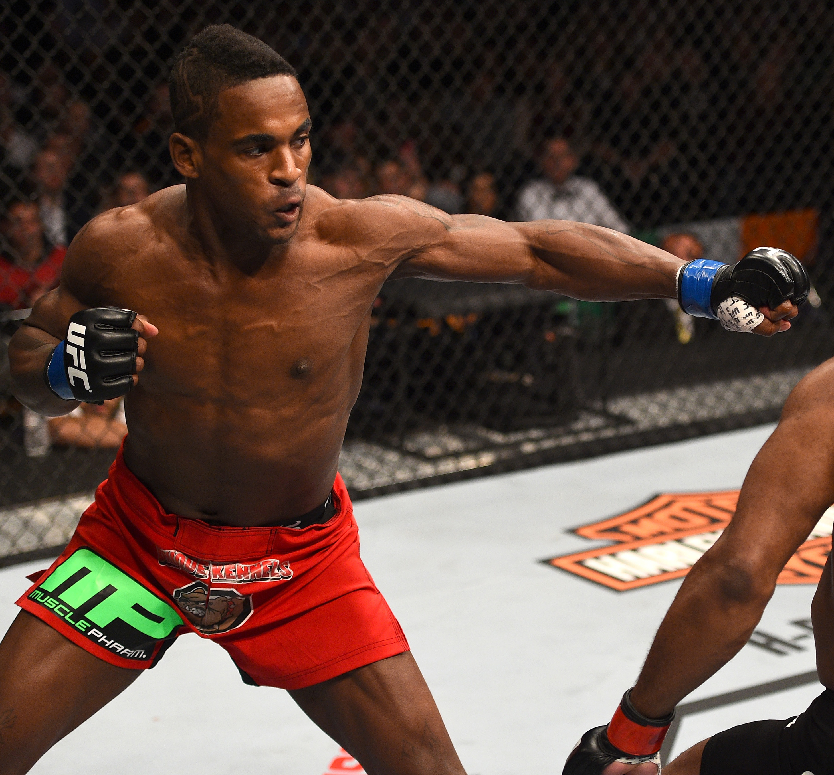 (L-R) Lorenz Larkin punches John Howard in their welterweight fight during the UFC Fight Night event at the TD Garden on January 18, 2015 in Boston, Massachusetts. (Photo by Jeff Bottari/Zuffa LLC)