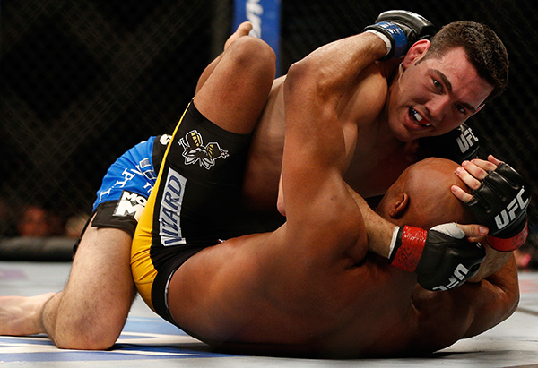 Chris Weidman (top) grapples with Anderson Silva in their UFC middleweight championship bout during the UFC 168 event at the MGM Grand Garden Arena on December 28, 2013 in Las Vegas, Nevada. (Photo by Josh Hedges/Zuffa LLC)