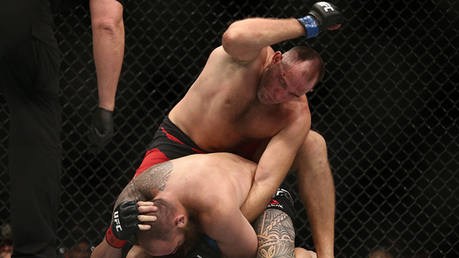 <a href='../fighter/Oleksiy-Oliynyk'>Aleksei Oleinik</a> punches <a href='../fighter/Travis-Browne'>Travis Browne</a> in their heavyweight bout during the UFC 213 event at T-Mobile Arena on July 9, 2017 in Las Vegas, Nevada. (Photo by Rey Del Rio/Getty Images)