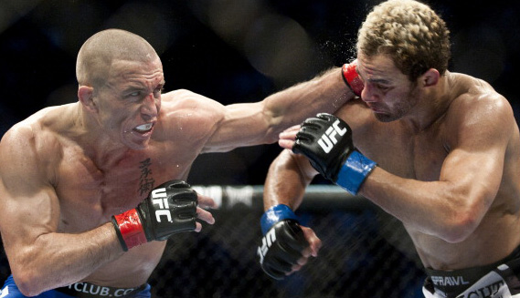 Georges St-Pierre (L) from Montreal, Canada punches Josh Koscheck from Waynesburg US during the third round of the Ultimate Fighting Championship on December 11, 2010 at Bell Centre in Montreal, Quebec, Canada. (Photo: ROGERIO BARBOSA/AFP)