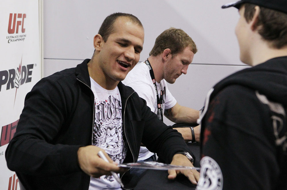 UFC Heavyweight contender Junior dos Santos signs an autograph for a fan at the UFC Fan Expo.