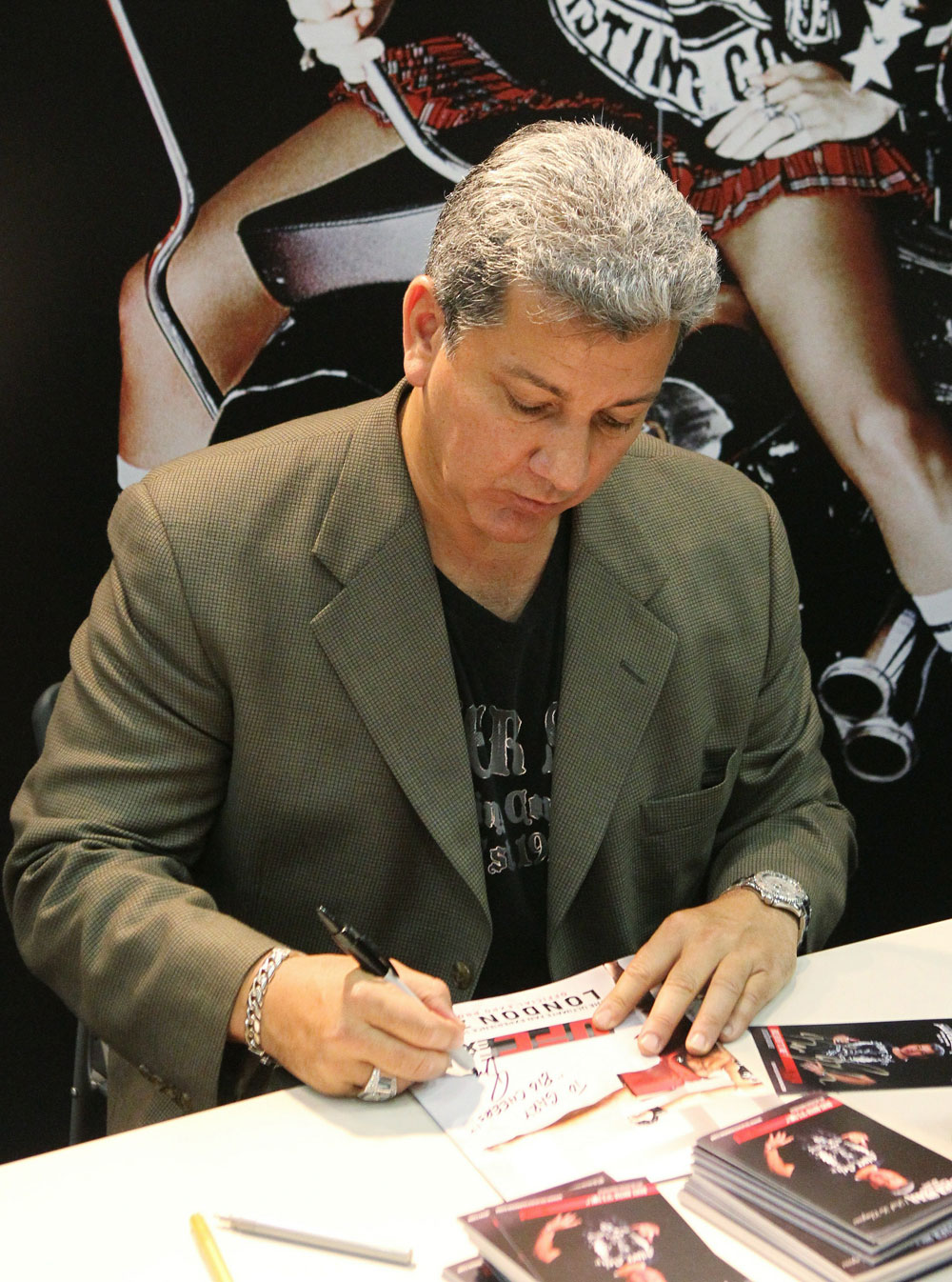UFC announces Bruce Buffer signs an autograph for a fan.