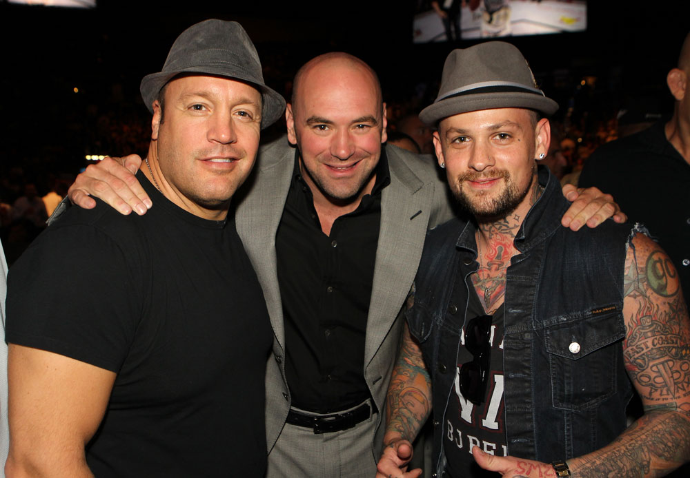 UFC President Dana White (center) poses for a photo with actor Kevin James (L) and musician Benji Madden (R) Octagonside.