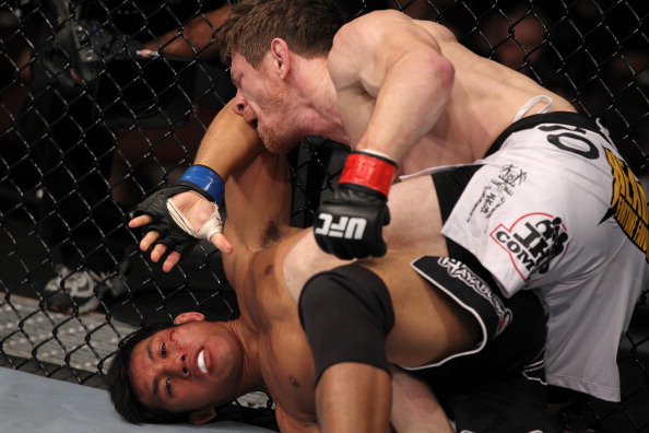 Mike Brown throws punches at Nam Phan at UFC 133 Mike Brown throws punches at Nam Phan at UFC 133