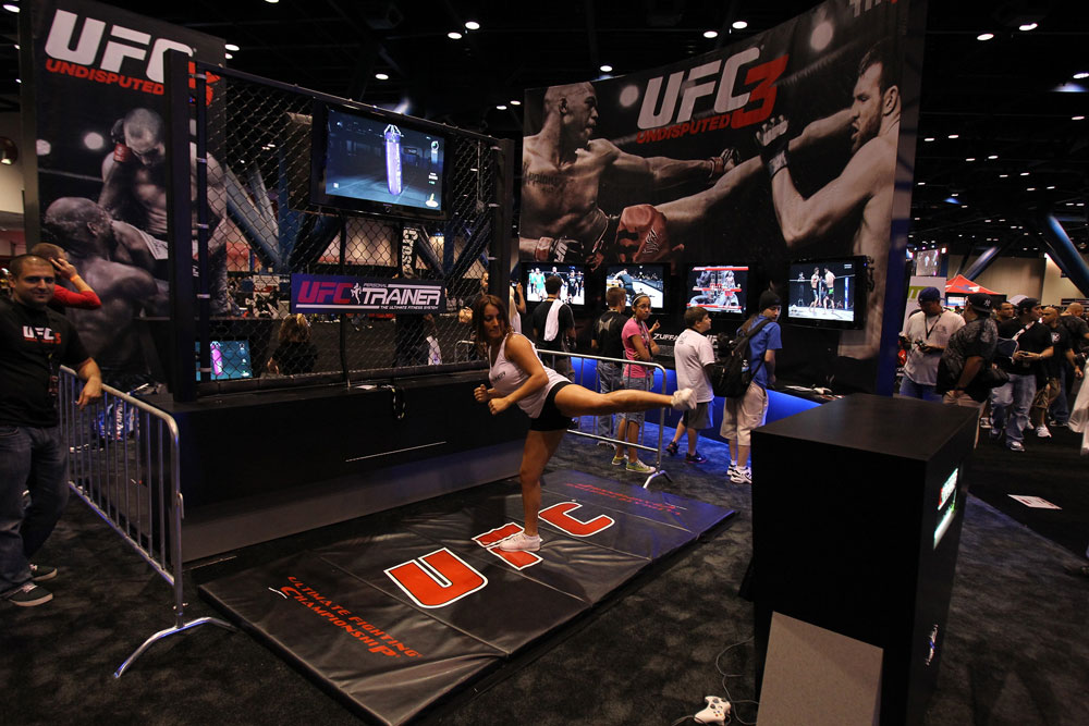 A trainer demonstrates the UFC Personal Trainer videogame