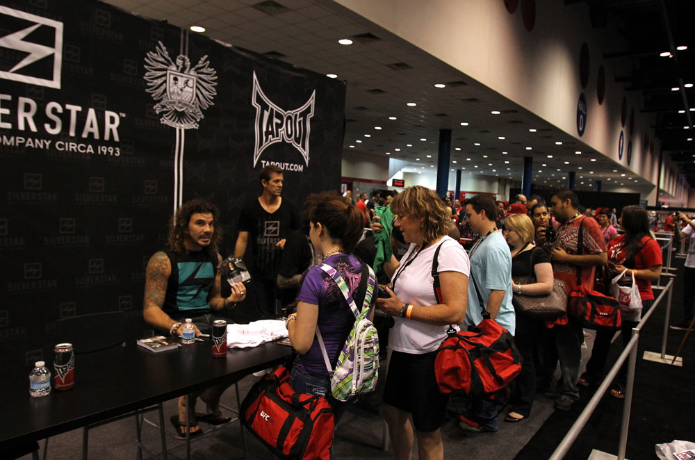 UFC Fighter Clay Guida signs autographs for fans