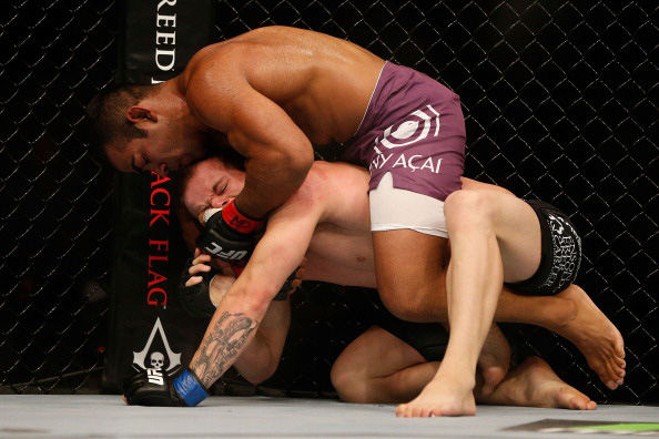 Prazeres attempts to lock in a choke hold Prazeres attempts to lock in a choke hold