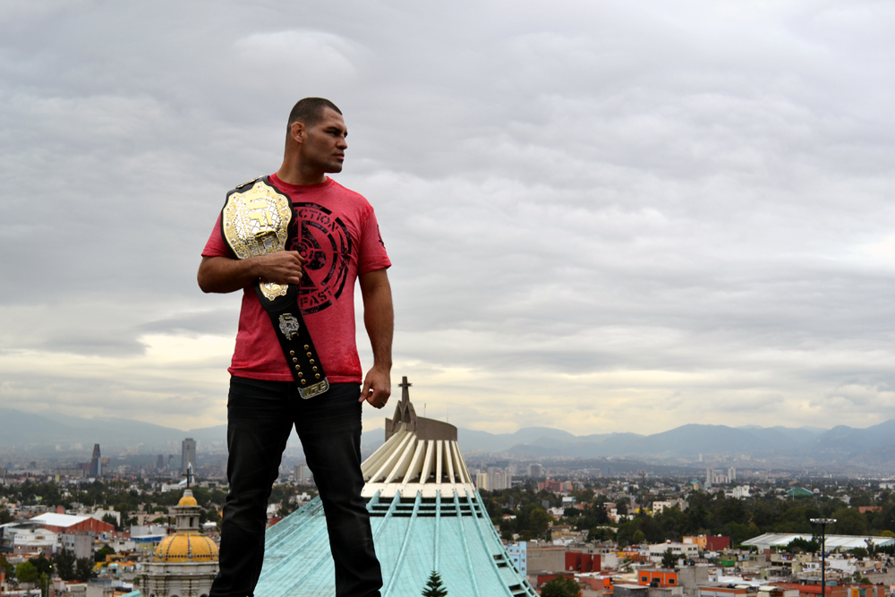 Velasquez posses with his belt in front of “La Villa”, home of “La Vigen de Guadalupe”, the most important religious icon in Mexico. (Juan Cardenas/Zuffa LLC)