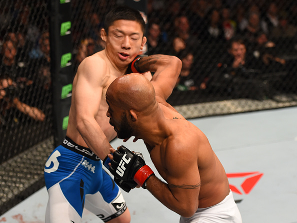 MONTREAL, QC - APRIL 25: (R-L) Demetrious Johnson of the United States punches Kyoji Horiguchi of Japan in their UFC flyweight championship bout during the UFC 186 event at the Bell Centre on April 25, 2015 in Montreal, Quebec, Canada. (Photo by Josh Hedges/Zuffa LLC/Zuffa LLC via Getty Images)