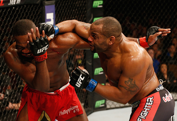 LAS VEGAS, NV - JANUARY 03: Daniel Cormier (R) punches Jon Jones (L) in their UFC light heavyweight championship bout during the UFC 182 event at the MGM Grand Garden Arena on January 3, 2015 in Las Vegas, Nevada. (Photo by Josh Hedges/Zuffa LLC/Zuffa LLC via Getty Images)
