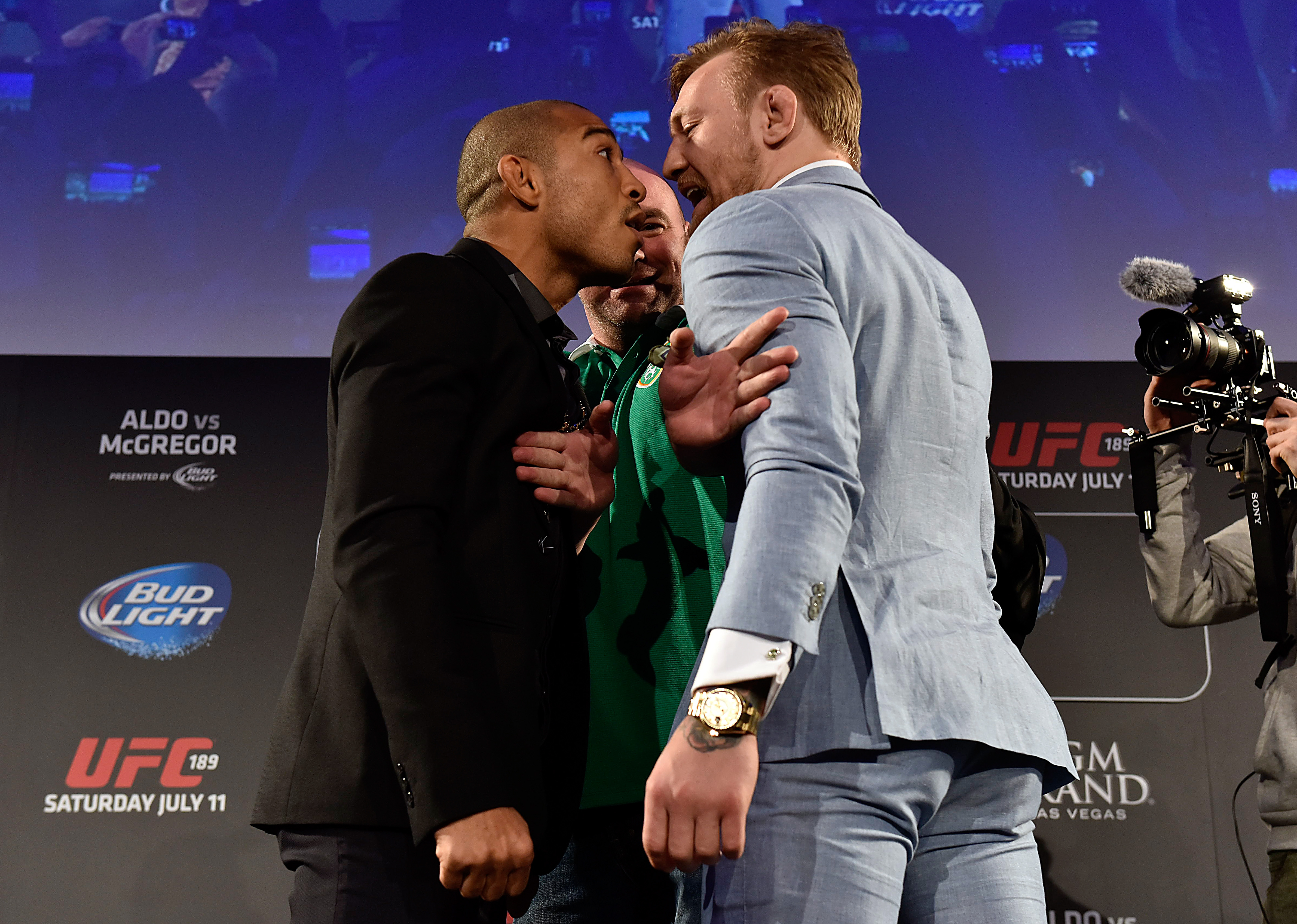 UFC President Dana White (C) separates UFC Featherweight Champion Jose Aldo of Brazil (L) and title challenger Conor 'The Notorious' McGregor of Ireland (R) as they face off during the UFC 189 World Championship Fan Event on March 31, 2015 in Dublin, Ireland. (Photo by Jeff Bottari/Zuffa LLC)