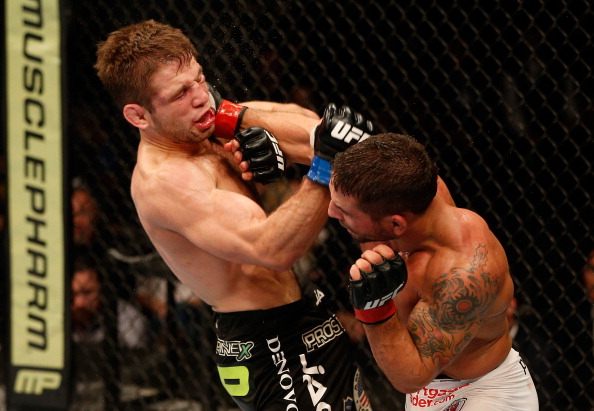 Chad Mendes punches Nik Lentz in their featherweight bout during the UFC on FOX event at Sleep Train Arena on December 14, 2013 in Sacramento, California. (Photo by Josh Hedges/Zuffa LLC)