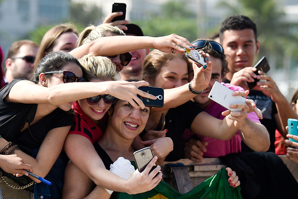 Women's bantamweight contender Bethe Correia of Brazil poses with fans during open training session at Pepe Beach on July 29, 2015 in Rio de Janeiro, Brazil. (Photo by Buda Mendes/Zuffa LLC)