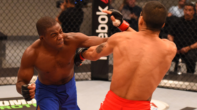 Fernando Acouguerio punches Bruno Murata during the TUF Brazil season four elimination fights at the UFC Training Center on February 2, 2015 in Las Vegas, Nevada. (Photo by Josh Hedges/Zuffa LLC))