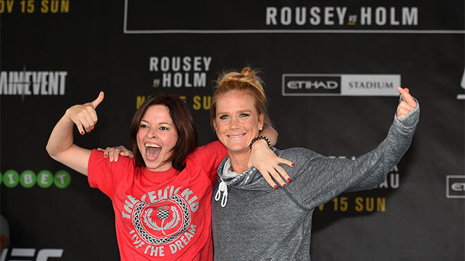 MELBOURNE, AUSTRALIA - NOVEMBER 12: Holly Holm of the United States brings a fan on stage to help with her open workout for fans and media at Federation Square on November 12, 2015 in Melbourne, Australia. (Photo by Josh Hedges/Zuffa LLC)
