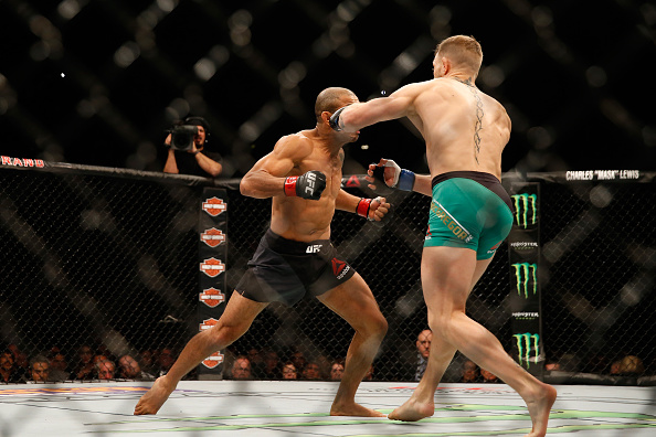 (R-L) Conor McGregor of Ireland punches Jose Aldo of Brazil in their UFC welterweight championship bout during the UFC 194 event inside MGM Grand Garden Arena on December 12, 2015 in Las Vegas, Nevada. (Photo by Christian Petersen/Zuffa LLC)