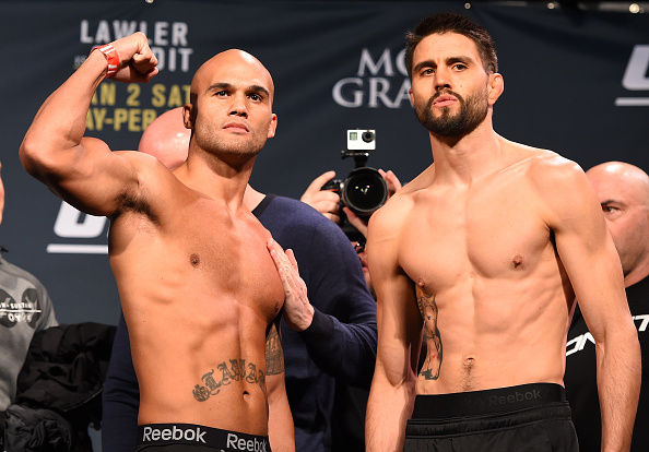 (L-R) UFC welterweight champion Robbie Lawler and opponent Carlos Condit pose for photos during the UFC 195 weigh-in at the MGM Grand Conference Center on January 1, 2016 in Las Vegas, Nevada. (Photo by Josh Hedges)