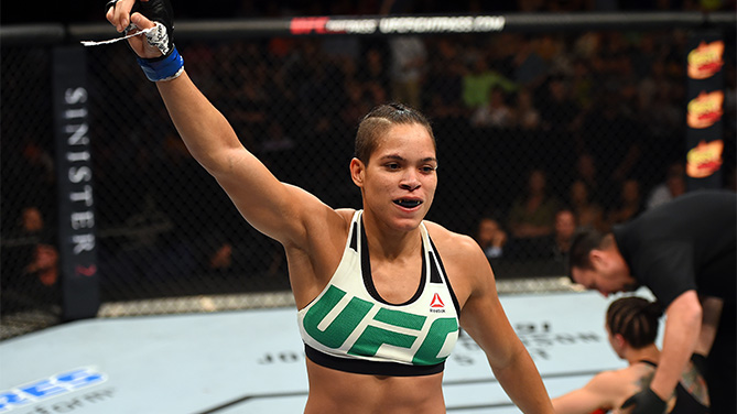 (L-R) Amanda Nunes of Brazil celebrates after defeating Sara McMann in their women's bantamweight bout during the UFC Fight Night event at Bridgestone Arena on August 8, 2015 in Nashville, Tennessee. (Photo by Josh Hedges/Zuffa LLC)