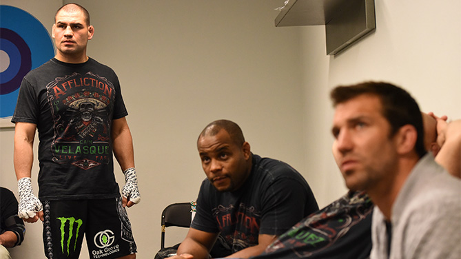 (L-R) Cain Velasquez warms up in his locker room backstage with team mates Daniel Cormier and Luke Rockhold during the UFC 188 event at the Arena Ciudad de Mexico on June 13, 2015 in Mexico City, Mexico. (Photo by Mike Roach/Zuffa LLC)