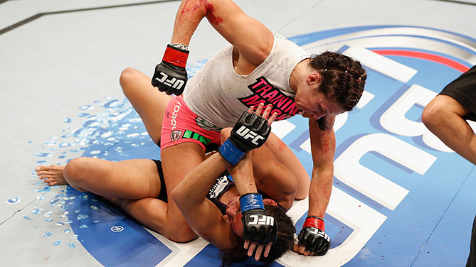 LAS VEGAS, NV - SEPT. 27: (Top) <a href='../fighter/Cat-Zingano'>Cat Zingano</a> punches <a href='../fighter/Amanda-Nunes'>Amanda Nunes</a> in their women's bantamweight fight during the UFC 178 event inside the MGM Grand Garden Arena. (Photo by Josh Hedges/Zuffa LLC)