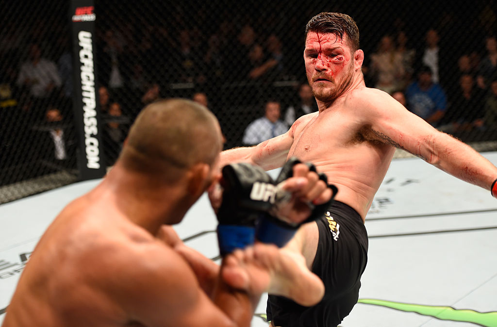 MANCHESTER, ENGLAND - OCTOBER 08: (R-L) Michael Bisping of England kicks Dan Henderson in their UFC middleweight championship bout during the UFC 204 Fight Night at the Manchester Evening News Arena. (Photo by Josh Hedges/Zuffa LLC)