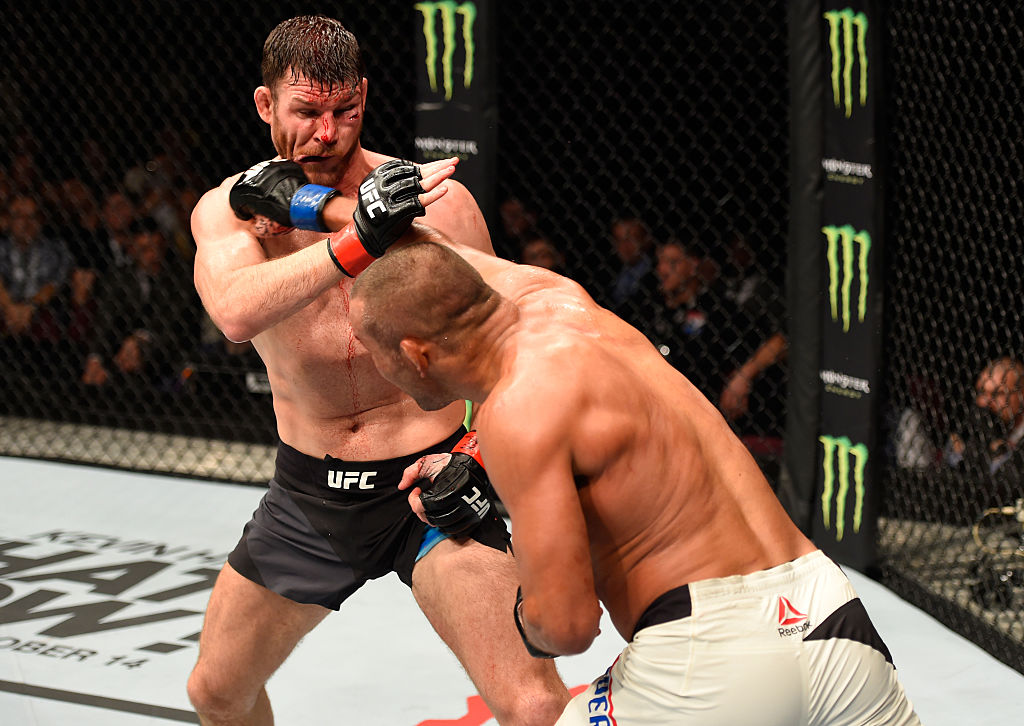 MANCHESTER, ENGLAND - OCTOBER 08: (R-L) Dan Henderson punches Michael Bisping of England in their UFC middleweight championship bout during the UFC 204 Fight Night at the Manchester Evening News Arena. (Photo by Josh Hedges/Zuffa LLC)
