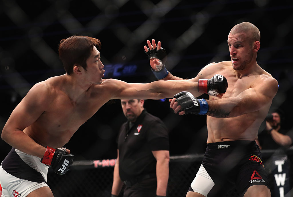 Dong Hyun Kim of South Korea punches Tarec Saffiedine of Belgium in their welterweight bout. (Photo by Christian Petersen/Getty Images)