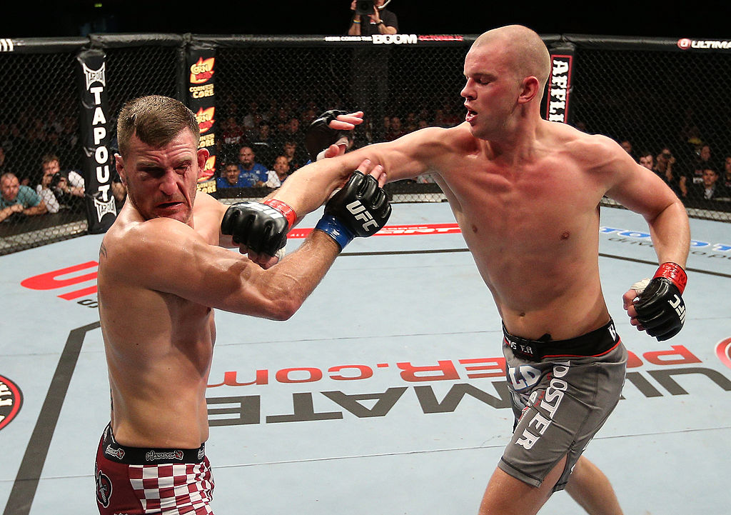 <a href='../fighter/Stefan-Struve'>Stefan Struve</a> punches <a href='../fighter/Stipe-Miocic'>Stipe Miocic</a> during their heavyweight bout in 2012