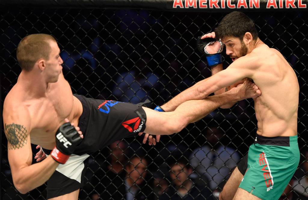 DALLAS, TX - MAY 13: (L-R) James Vick kicks Marco Polo Reyes in their lightweight fight during the UFC 211 event at the American Airlines Center on May 13, 2017 in Dallas, Texas. (Photo by Josh Hedges/Zuffa LLC)