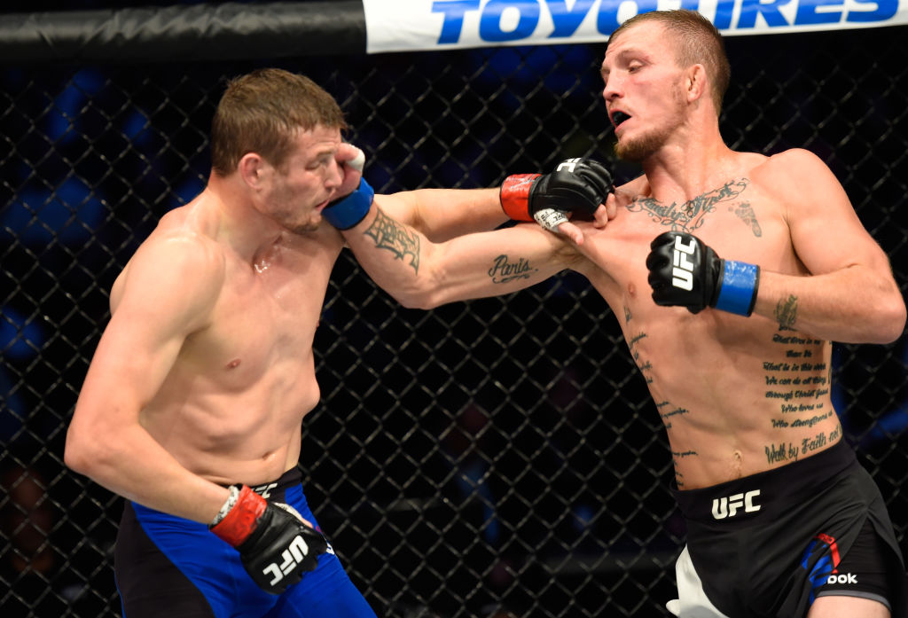 DALLAS, TX - MAY 13: (R-L) Jason Knight punches Chas Skelly in their featherweight fight during the UFC 211 event at the American Airlines Center on May 13, 2017 in Dallas, Texas. (Photo by Josh Hedges/Zuffa LLC)
