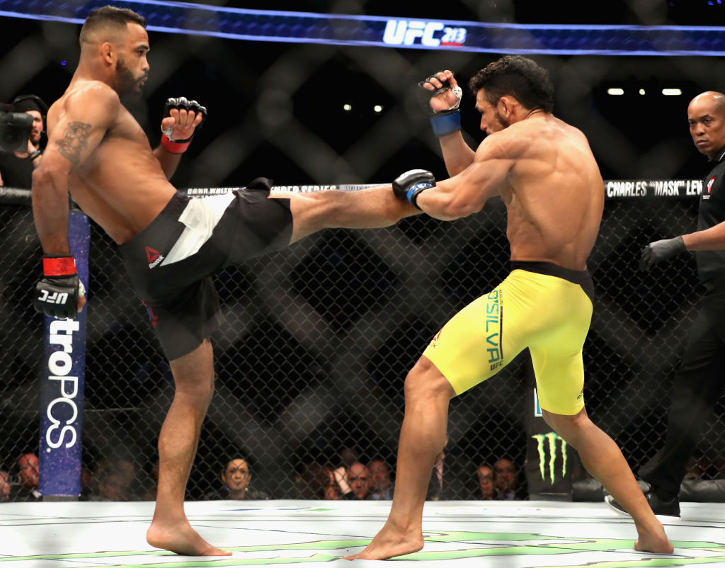 LAS VEGAS, NV - JULY 08: (L-R) <a href='../fighter/Rob-Font'>Rob Font</a> kicks <a href='../fighter/Douglas-Silva-de-Andrade'>Douglas Silva de Andrade</a> of Brazil in their bantamweight bout during the UFC 213 event at T-Mobile Arena on July 8, 2017 in Las Vegas, Nevada. (Photo by Christian Petersen/Zuffa LLC)
