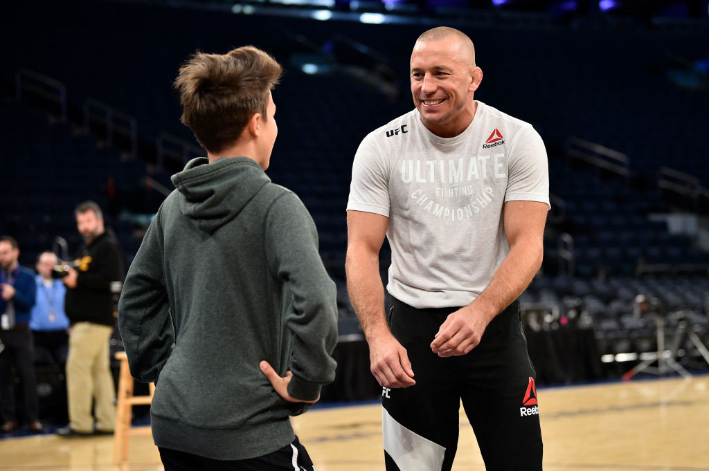 NEW YORK, NY - NOV. 01: Georges St-Pierre interacts with a fan as he holds an open workout session for fans and media inside Madison Square Garden. (Photo by Jeff Bottari/Zuffa LLC)