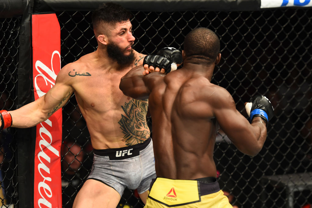 DETROIT, MI - DECEMBER 02: (R-L) Abdul Razak Alhassan of Ghana punches Sabah Homasi in their welterweight bout during the UFC 218 event inside Little Caesars Arena on December 02, 2017 in Detroit, Michigan. (Photo by Josh Hedges/Zuffa LLC)