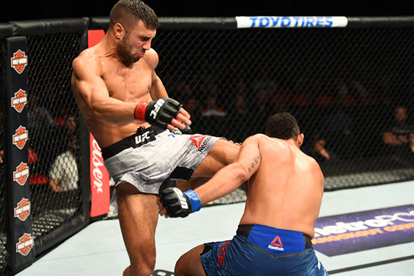 DETROIT, MI - DECEMBER 02: (L-R) David Teymur of Sweden lands a knee to the body of Drakkar Klose in their lightweight bout during the UFC 218 event inside Little Caesars Arena on December 02, 2017 in Detroit, Michigan. (Photo by Josh Hedges/Zuffa LLC)