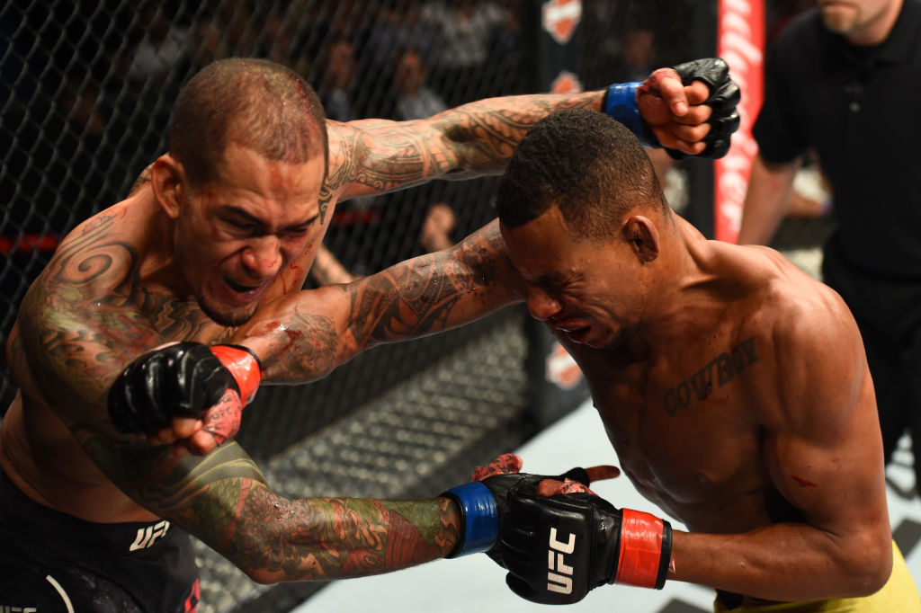 Alex Oliveira of Brazil punches Yancy Medeiros during UFC 218 on December 02, 2017 in Detroit, Michigan. (Photo by Josh Hedges/Zuffa LLC)