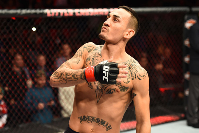 DETROIT, MI - DECEMBER 02: <a href='../fighter/Max-Holloway'>Max Holloway</a> signals to the crowd as he enters the Octagon prior to facing <a href='../fighter/Jose-Aldo'>Jose Aldo</a> of Brazil in their UFC featherweight championship bout during the UFC 218 event inside Little Caesars Arena on December 02, 2017 in Detroit, Michigan. (Photo by Josh Hedges/Zuffa LLC/Zuffa LLC via Getty Images)