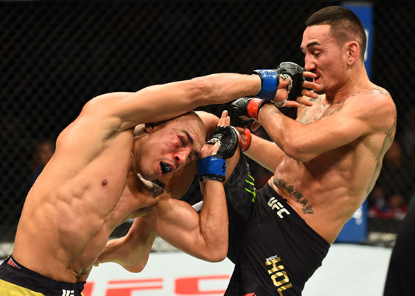 (R-L) <a href='../fighter/Max-Holloway'><a href='../fighter/Max-Holloway'>Max Holloway</a></a> lands a knee against <a href='../fighter/Jose-Aldo'><a href='../fighter/Jose-Aldo'>Jose Aldo</a></a> of Brazil in their UFC featherweight championship bout during the UFC 218 event inside Little Caesars Arena on December 02, 2017 in Detroit, Michigan. (Photo by Josh Hedges/Zuffa LLC)