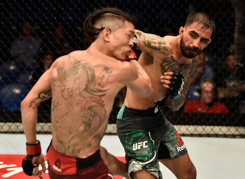 FEBRUARY 11: (R-L) Jose Quinonez of Mexico punches Teruto Ishihara of Japan in their bantamweight bout during the UFC 221 event at Perth Arena on February 11, 2018 in Perth, Australia. (Photo by Jeff Bottari/Zuffa LLC)
