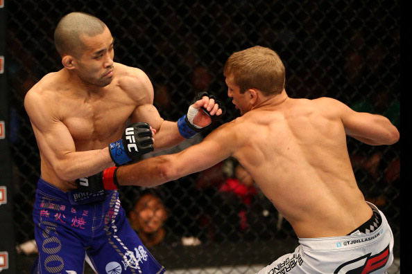 Dillashaw lands a body blow against Tamura Dillashaw lands a body blow against Tamura