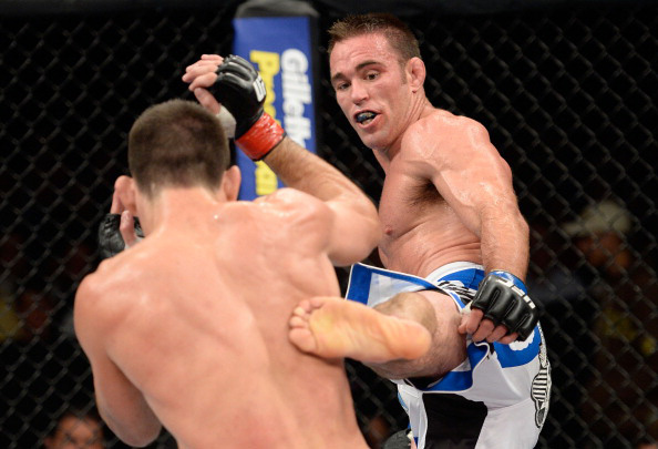 Shields lands a leg kick to the body of Maia Shields lands a leg kick to the body of Maia