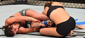 (L-R) Alex Chambers attempts to submit Kailin Curran in their women's strawweight bout during the UFC Fight Night on May 10, 2015 in Australia. (Photo by Josh Hedges/Zuffa LLC)