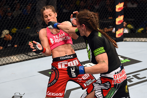 Lauren Murphy punches <a href='../fighter/Liz-Carmouche'>Liz Carmouche</a> in their women's bantamweight fight during the <a href='../event/UFC-Silva-vs-Irvin'>UFC Fight Night </a>event at the Patriot Center on April 4, 2015 in Fairfax, Virginia. (Photo by Josh Hedges/Zuffa LLC)