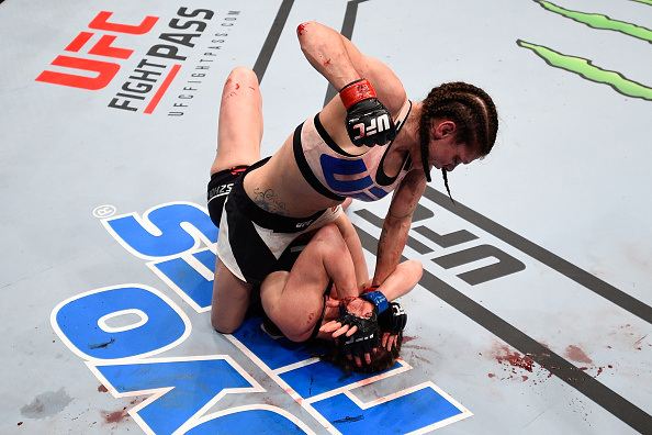 Lauren Murphy (top) punches Faszholz in their women's bantamweight bout during the <a href='../event/UFC-Silva-vs-Irvin'>UFC Fight Night </a>event at Consol Energy Center on February 21, 2016 in Pittsburgh, PA. (Photo by Jeff Bottari/Zuffa LLC)