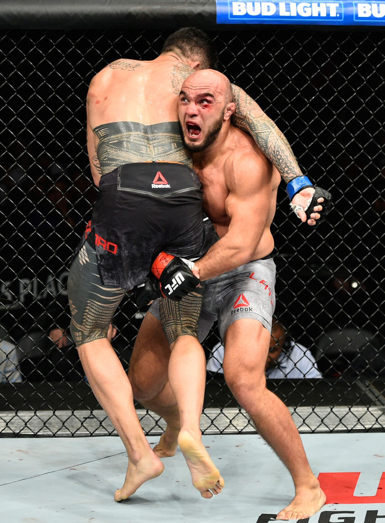 EDMONTON, AB - SEPTEMBER 09: (R-L) <a href='../fighter/Ilir-Latifi'>Ilir Latifi</a> of Sweden takes down <a href='../fighter/tyson-pedro'>Tyson Pedro</a> of Australia in their light heavyweight bout during the UFC 215 event inside the Rogers Place on September 9, 2017 in Edmonton, Alberta, Canada. (Photo by Jeff Bottari/Zuffa LLC)